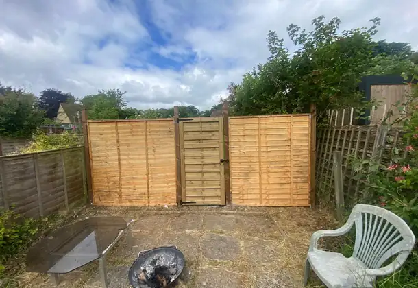 Professional fence repair work completed on residential property boundary