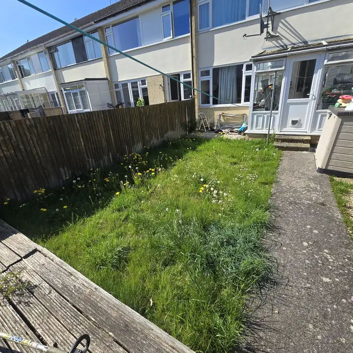 Neglected garden with debris before clearance in Bath